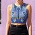 A women's sleeveless, high-neck crop top made from a performance spandex knit fabric. The top is designed with a body-hugging fit and features a striking, symmetrical digital graphic of a zebra's face. The intricate print uses shades of electric blue, cobalt, and navy, contrasted with a shimmering silver glitter effect that outlines the zebra's stripes and features. The psychedelic, futuristic design covers the entire front of the shirt.